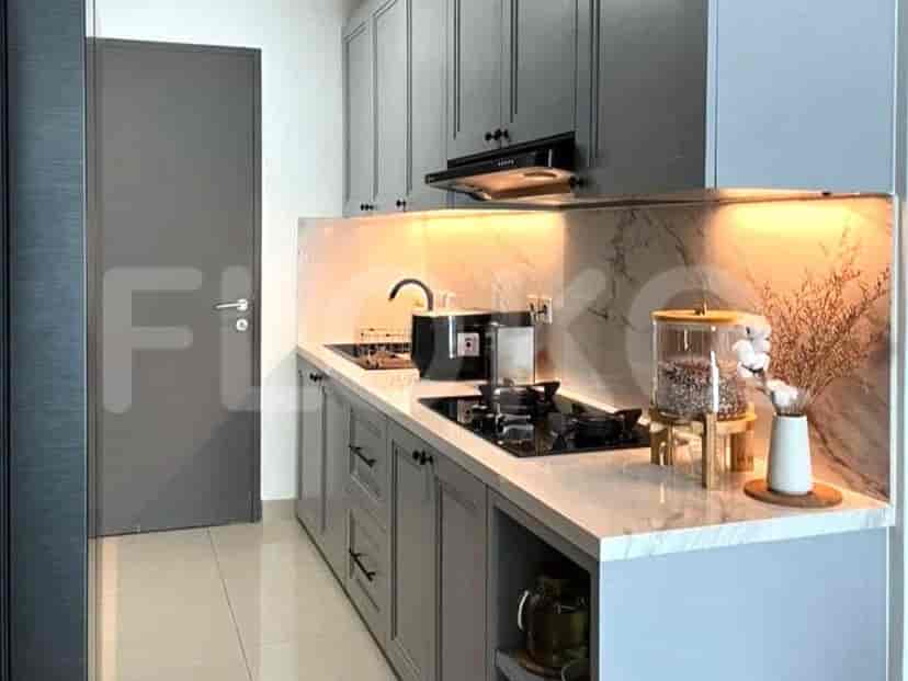 A modern kitchen with grey cabinets and white countertops.