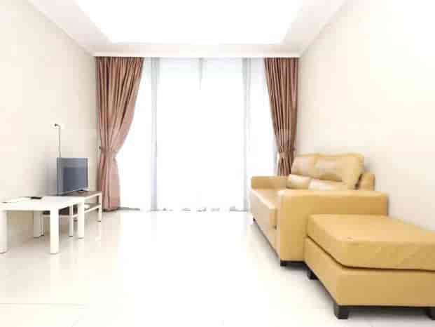 A bright living room with a yellow sofa, white table, and floor-to-ceiling window.