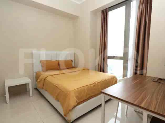 A modern bedroom with a double bed and a small table.
