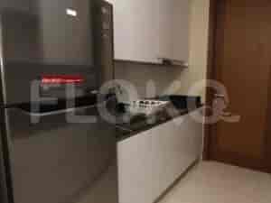 A modern kitchen with white cabinets and a refrigerator.