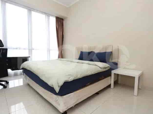 A bedroom with a double bed and a side table.