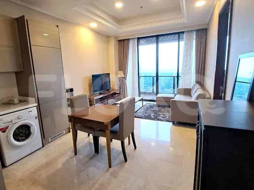 A combined kitchen and dining space featuring modern appliances, including a washing machine and dining table.
