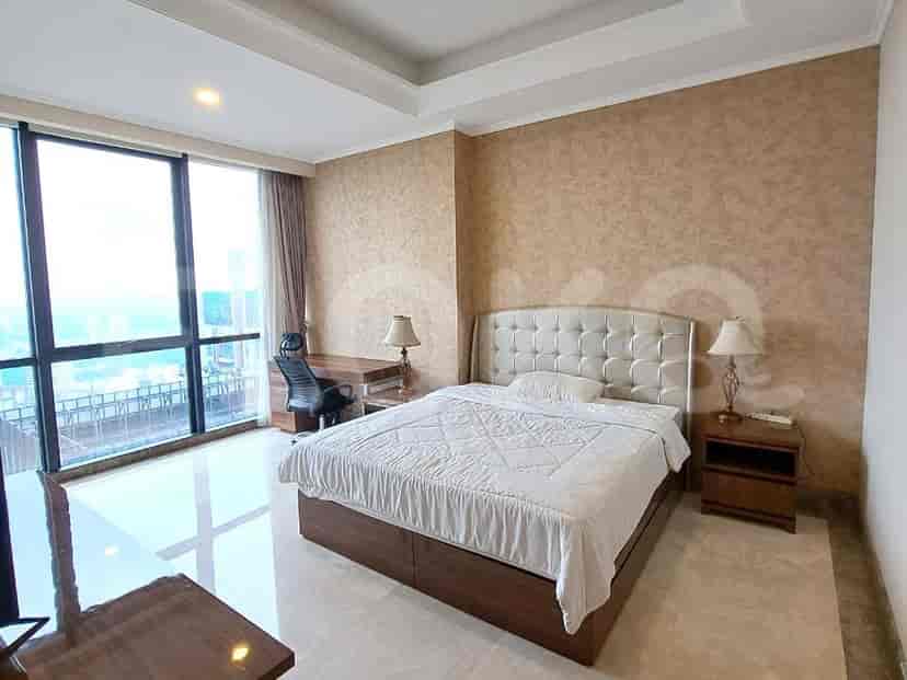 A spacious bedroom with a large bed, desk and a great city view.