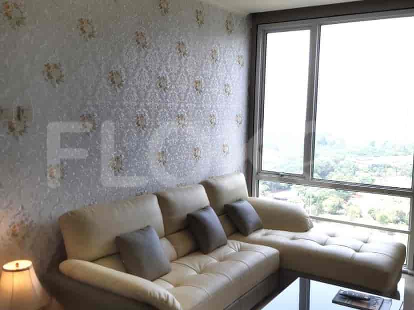 Living room featuring a beige L-shaped sofa, floral wallpaper, and a large window offering natural light.