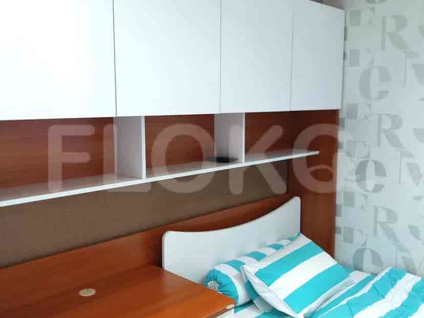 Bedroom featuring bed, floating shelves, and built-in storage.