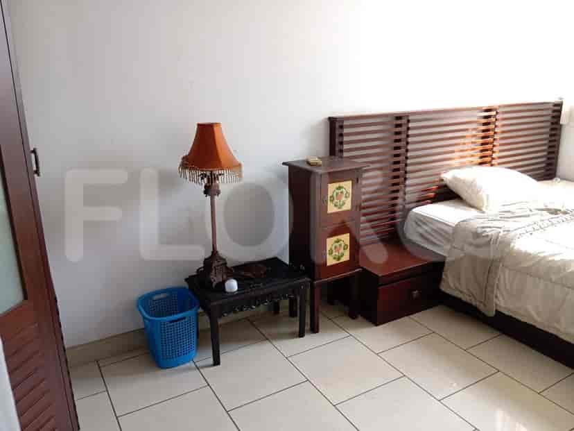 Bedroom with a bedside table, lamp, and a blue basket next to the bed