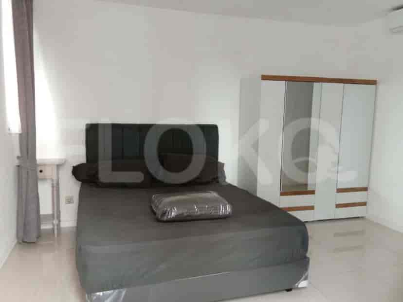 A bedroom with a large bed and a white closet.