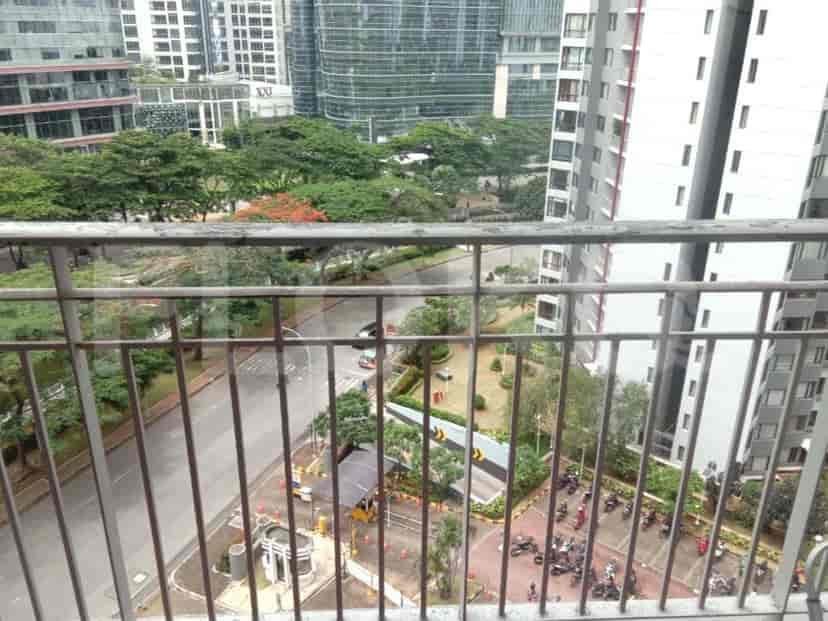 A balcony with a view of the city and surrounding buildings.