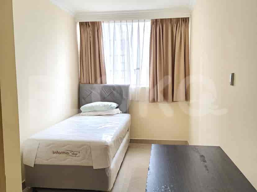 Small bedroom with a single bed and curtains.