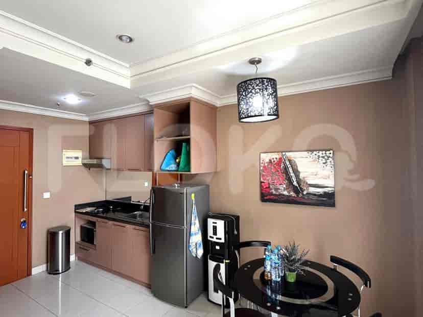 Modern kitchen with stainless steel appliances and dark cabinets.