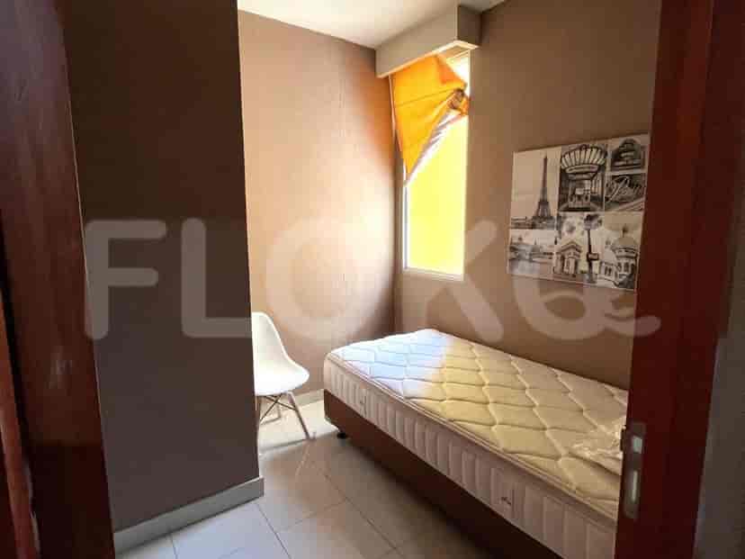 Small bedroom with single bed, artwork and window