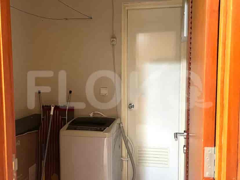 Laundry area with washing machine and drying rack.