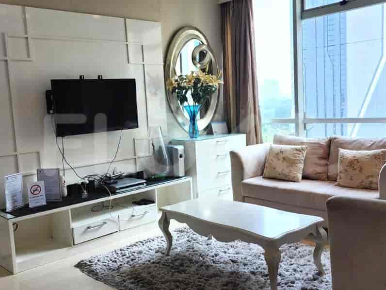 Living room with furniture including a sofa, coffee table, and a decorative mirror.