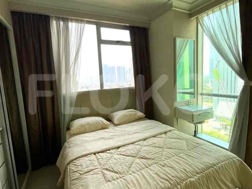 Bedroom with a bed, window, and curtains.