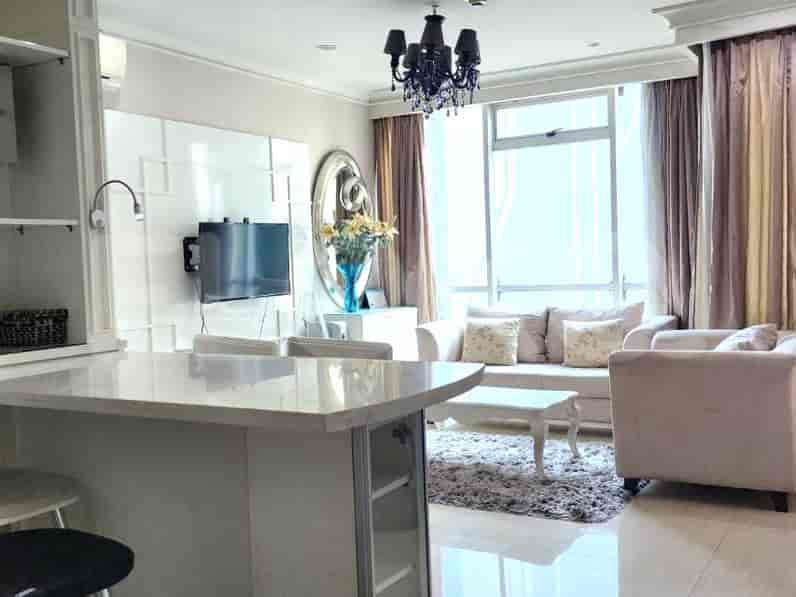 Living room with an open kitchen, seating, and an island counter.
