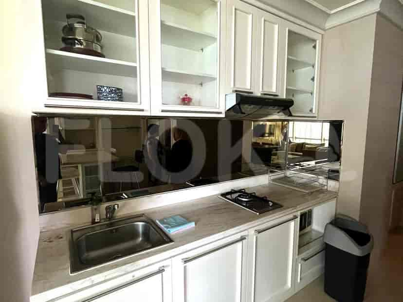 Kitchen with white cabinets, stove, and a sink.