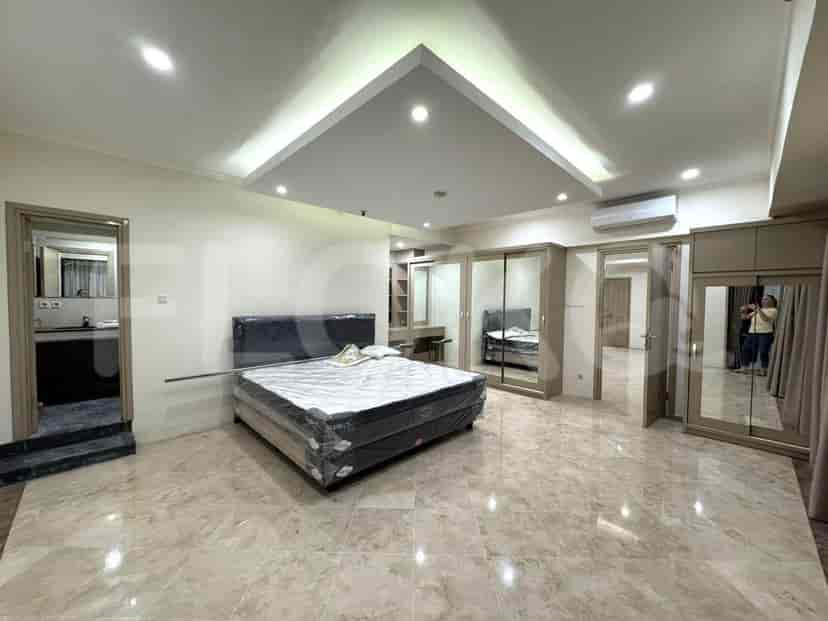 Bedroom with a large bed, marble flooring, and built-in closet.