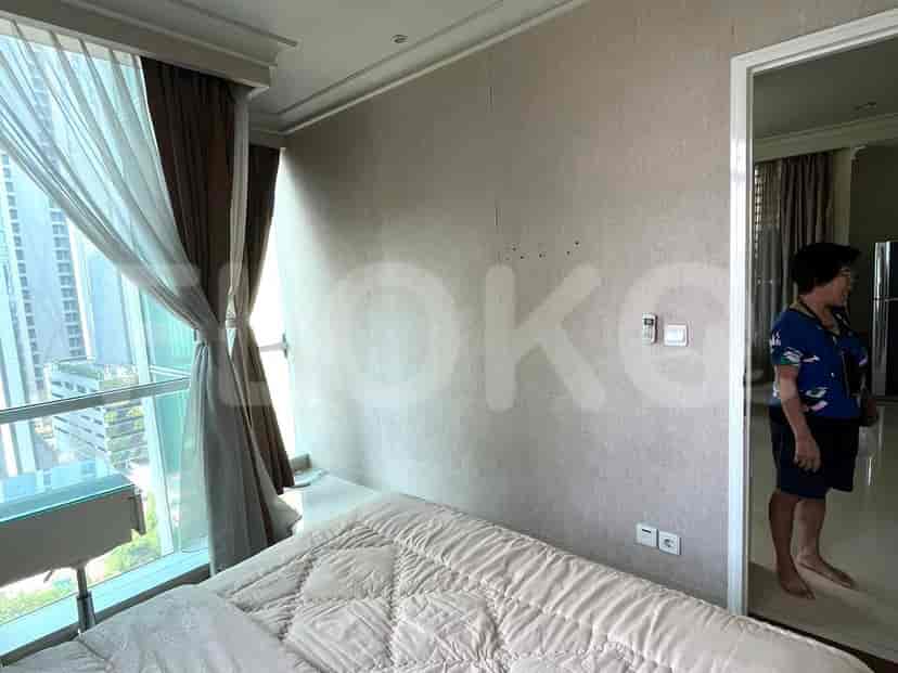 Bedroom with a bed, large window, and a glimpse of the adjacent area.