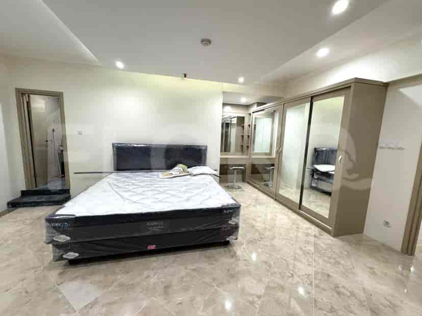 Bedroom with king-size bed, marble flooring, and a modern design.