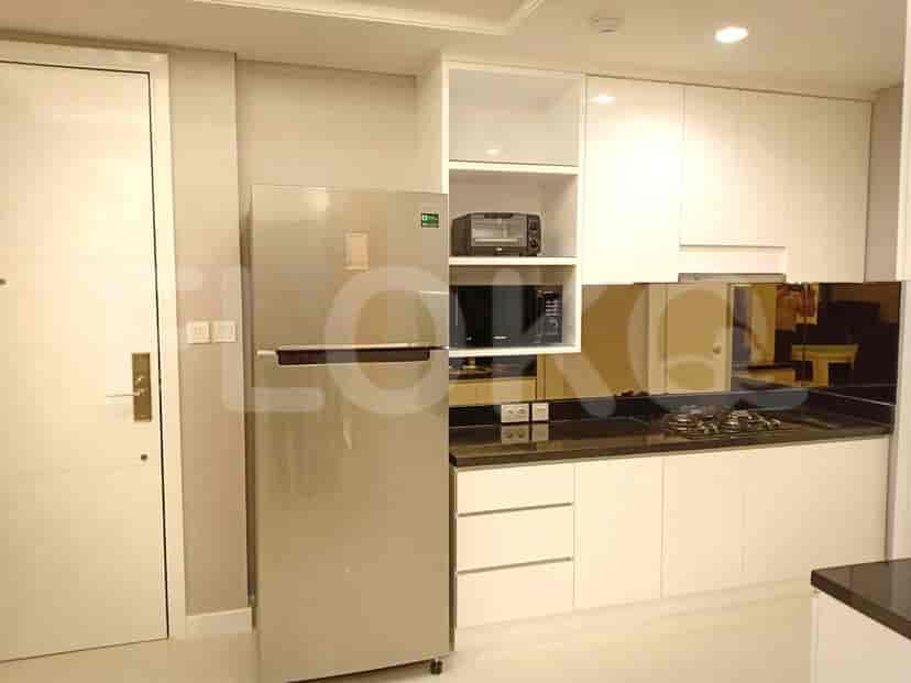 Modern kitchen with stainless steel appliances and white cabinets.