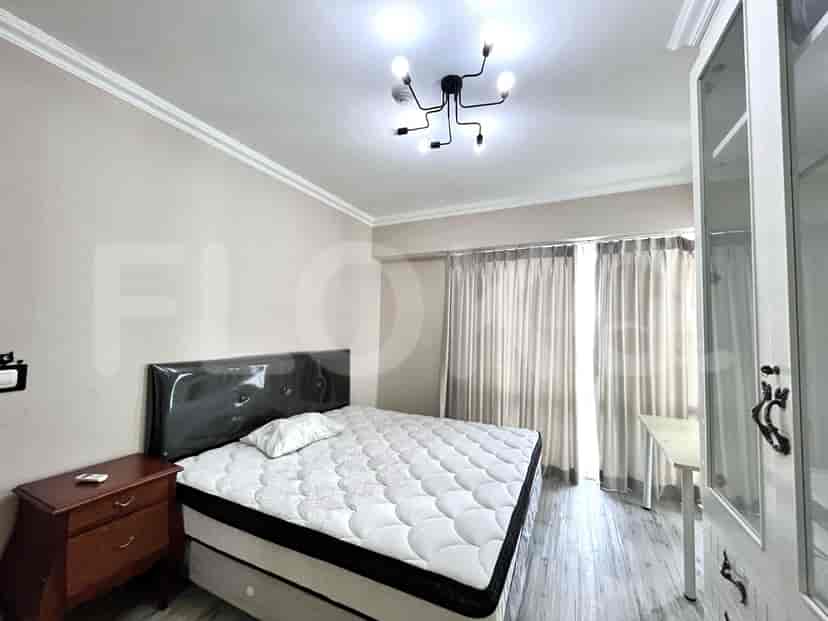 Bedroom with a double bed, nightstand, and a simple design.