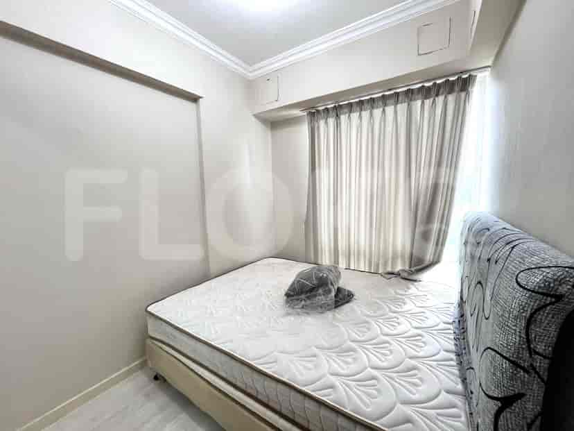 Bedroom with a double bed, curtains, and minimal furnishings.