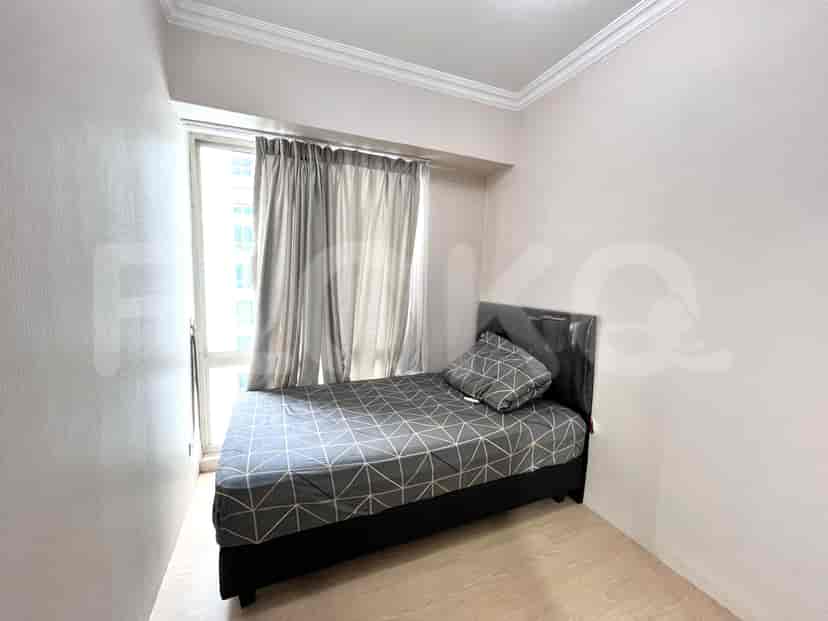 Bedroom with a single bed, curtains, and simple decor.