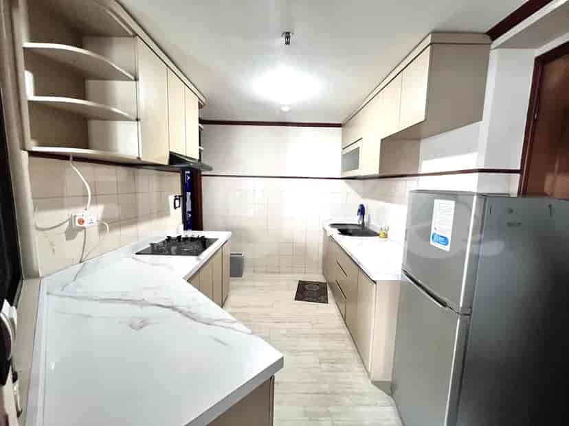 A modern kitchen with cabinets, countertops, and appliances.