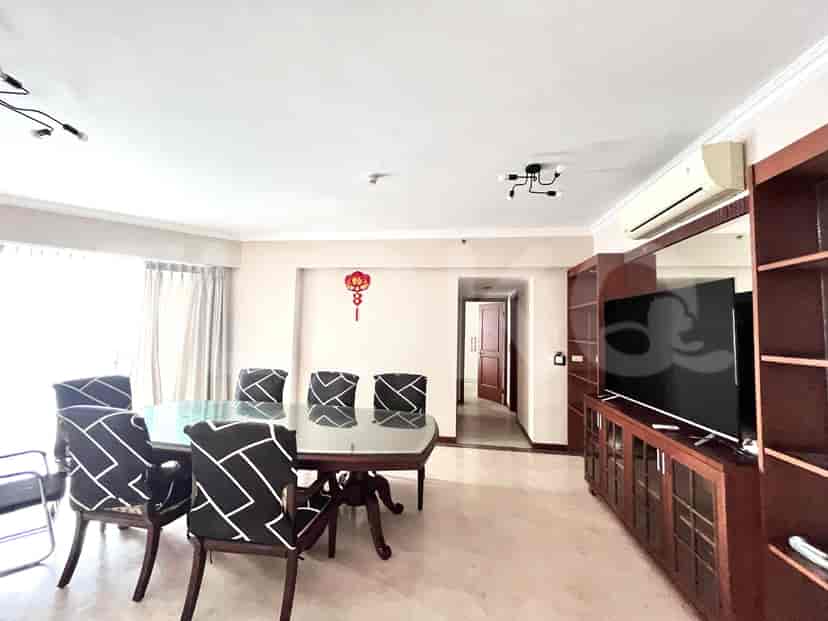 Dining area with a large table, several chairs, and access to other areas.