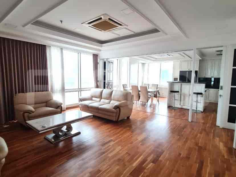 Elegant living room with leather sofas, a marble coffee table, and a view.