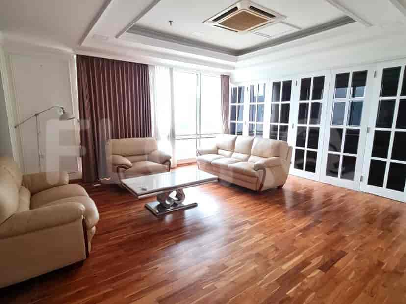 Bright living room with two sofas, large windows, and a marble coffee table.