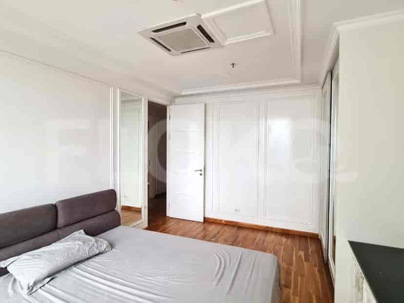 Bedroom with a bed, closet, and white trim.