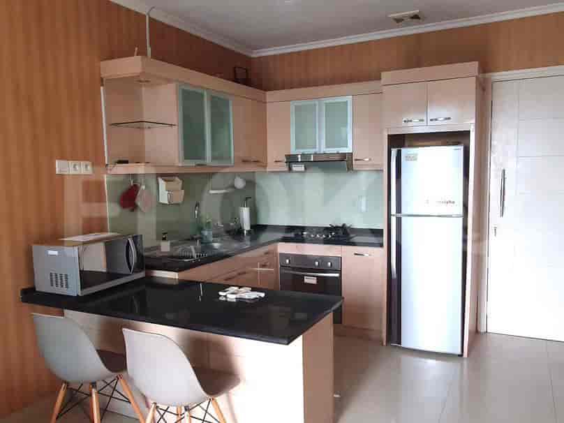 Modern kitchen with a black countertop, cabinets, and appliances.