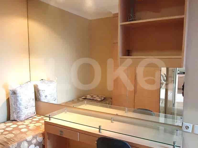 Small bedroom or study with a bed, desk, and mirror.
