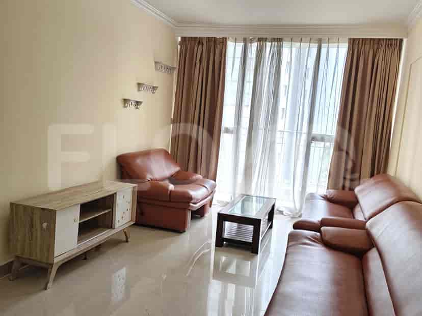 Living room with a sofa, armchair, coffee table, and cabinet.