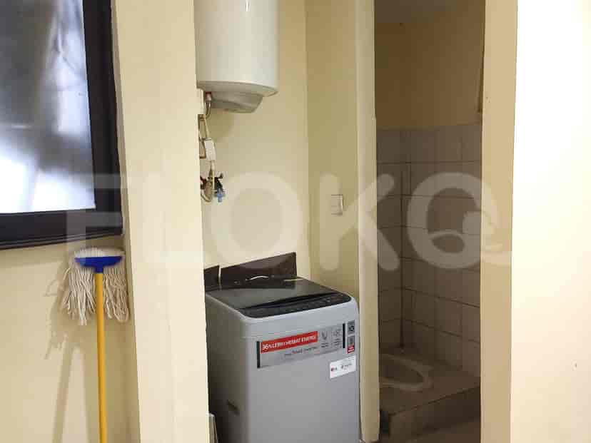 Bathroom area with washing machine and water heater.
