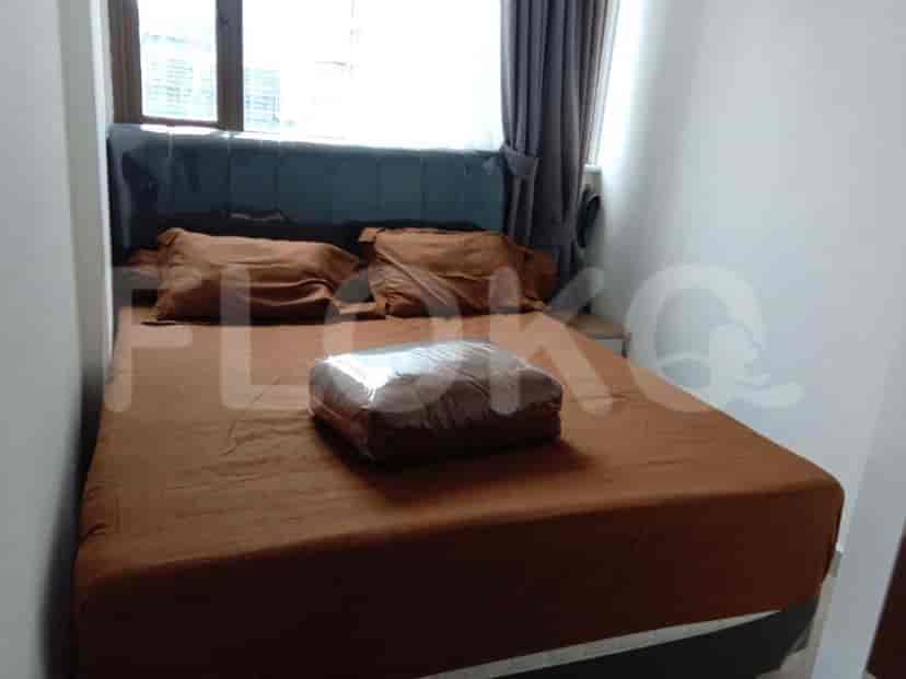 Bedroom with a brown bed and two pillows.