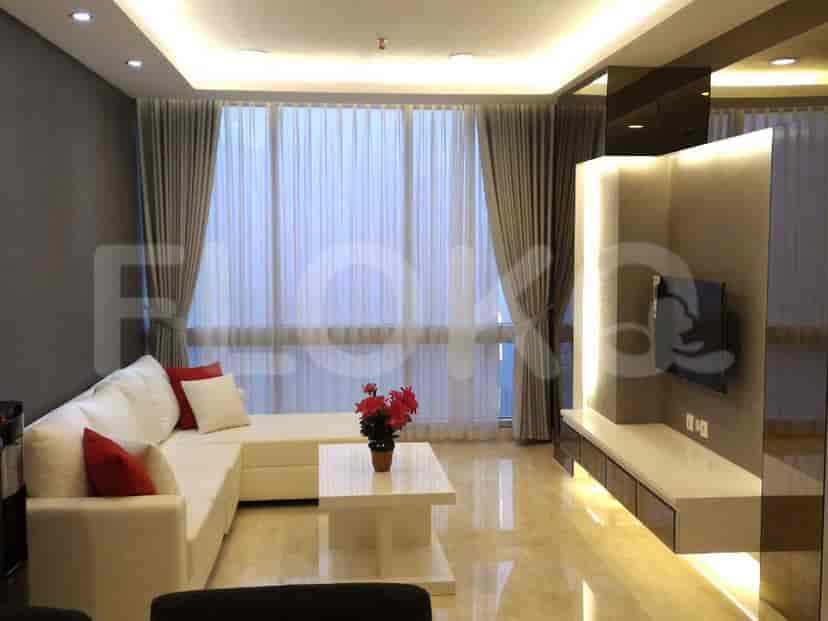 Modern living room with grey sofa, large window, and built-in entertainment unit.