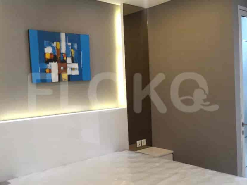 Bedroom with a large bed and modern art.
