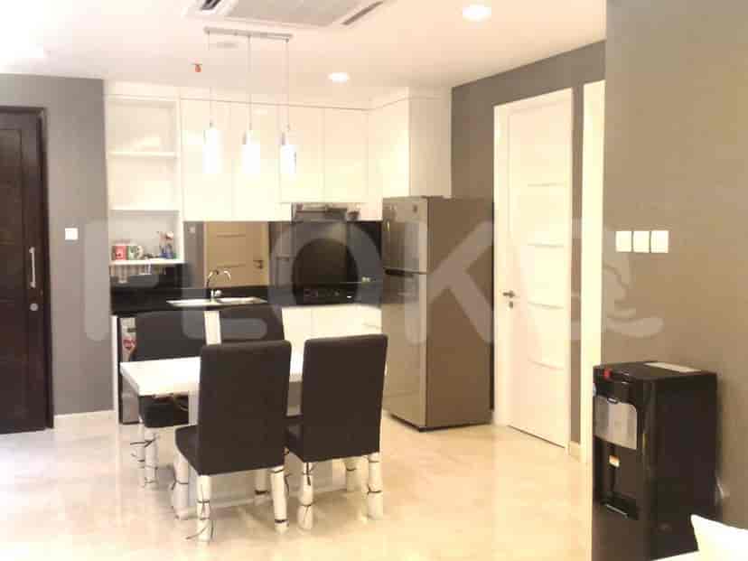 Modern kitchen with white cabinets and dining area.