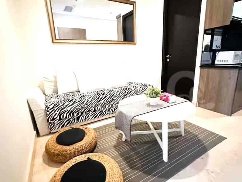 Living room showing a sofa with a zebra-print cover, coffee table, and ottomans.