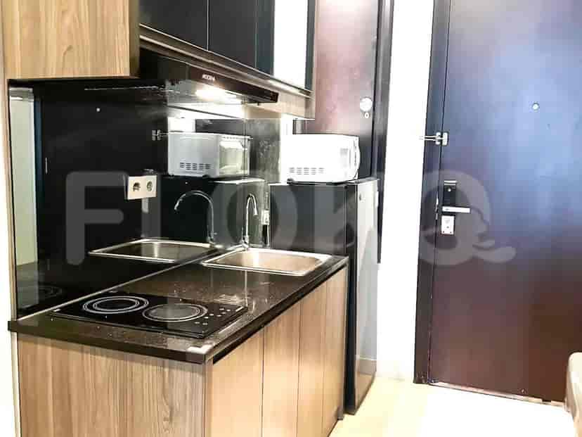 Compact kitchen with a modern design, including appliances and storage.