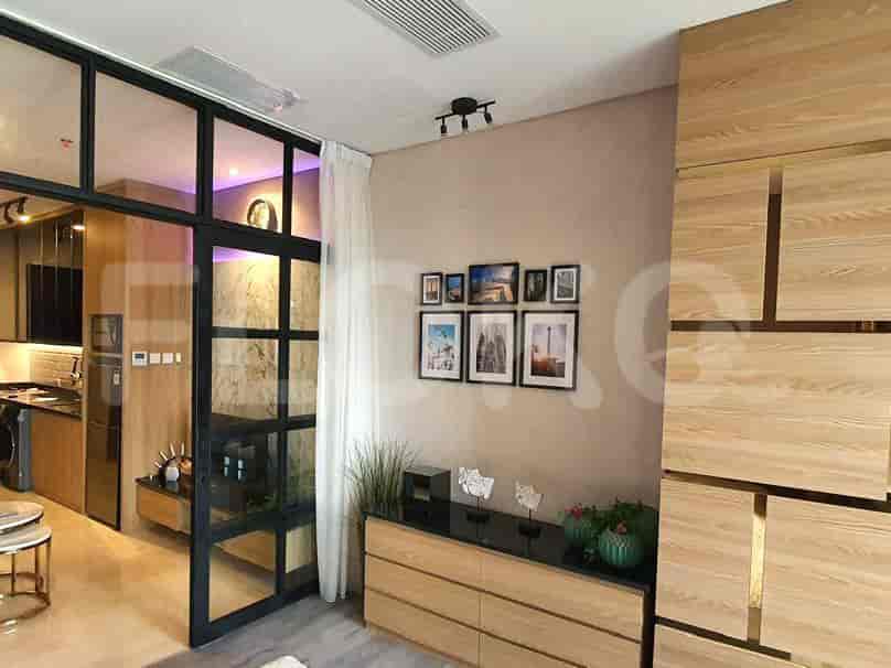 A view of the living room featuring artwork and a dresser.