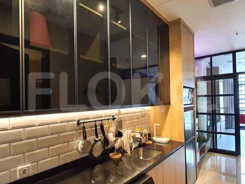 Kitchen with dark cabinets and stainless steel appliances.