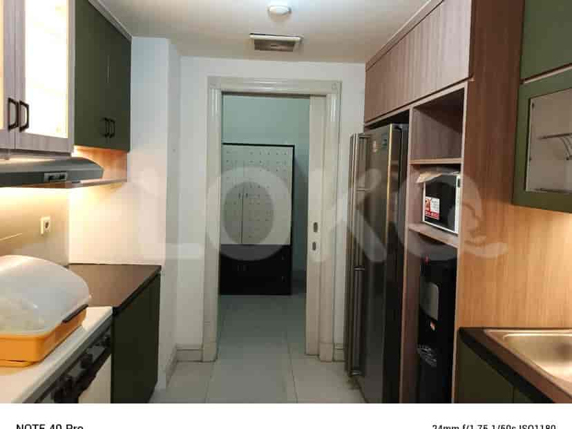 A kitchen with appliances and cabinets.