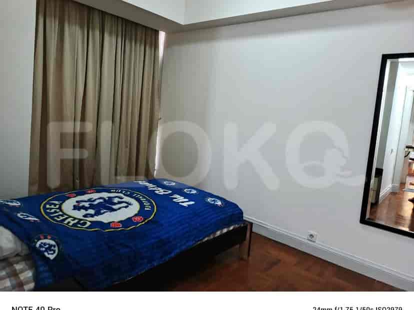 A bedroom with a bed and curtains.