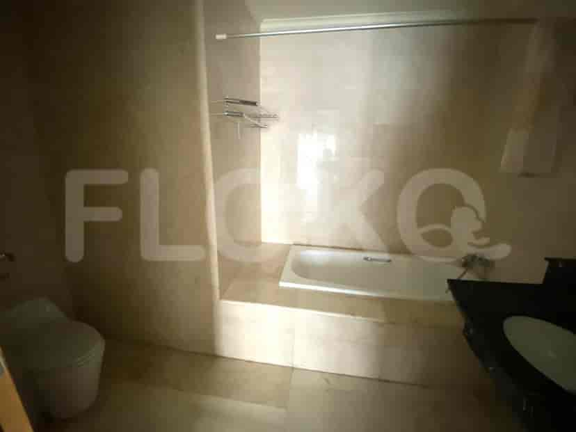Bathroom with a bathtub and tiled walls.