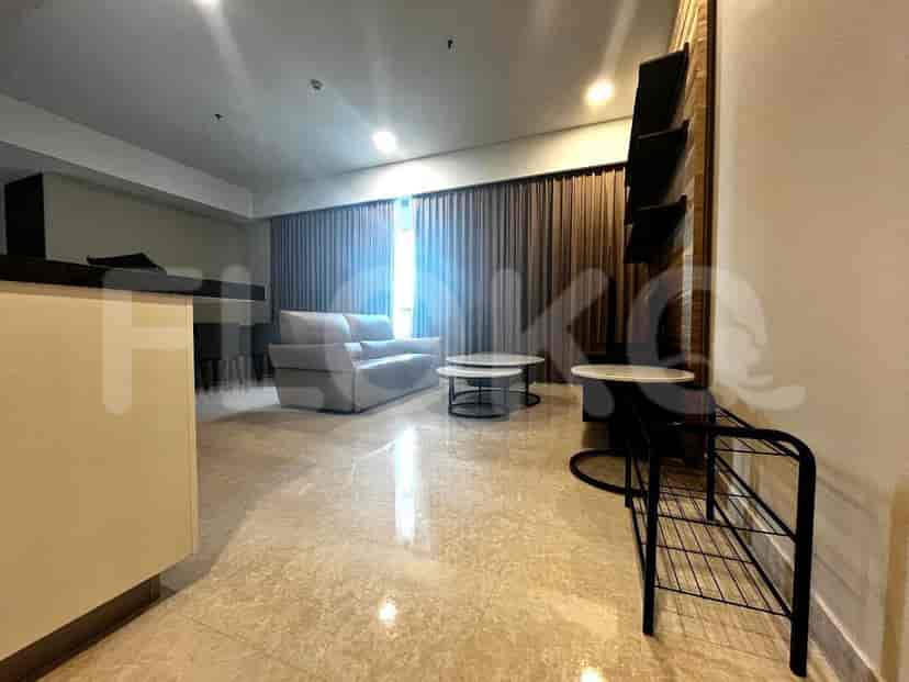 Living room with a grey sofa, coffee tables, and floor-to-ceiling curtains.