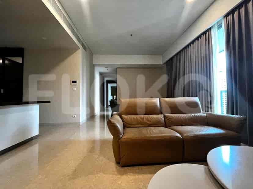 Living room featuring a leather sofa, marble flooring, and access to the hallway.