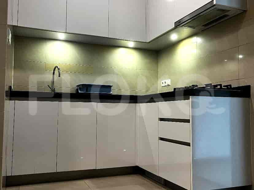 Modern kitchen with white cabinets and black countertops.